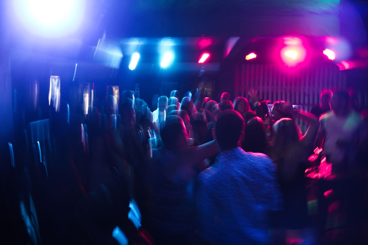 Crowd dancing under neon club lights